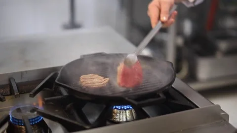 The Chef Turns The Meat In A Frying Pan Stock Footage 83587509