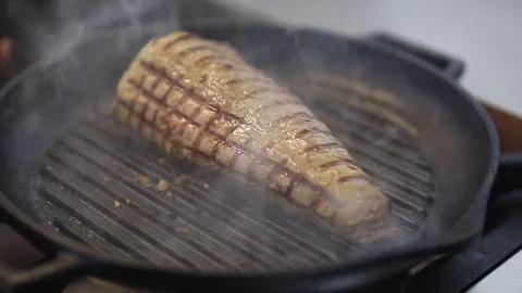 The Chef Turns The Meat In A Frying Pan Stock Footage 83587546