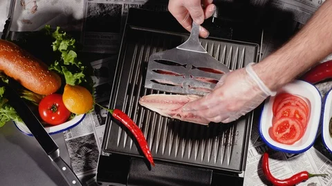 The chef turns one of the two halves of the mackerel fillet. Top view. Stock Footage 128291138