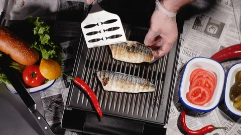 The chef turns one of the two halves of the mackerel fillet. Top view. Stock Footage 128291266