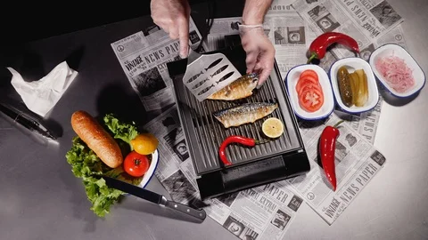 The chef turns one of the two halves of the mackerel fillet. Top view. Stock Footage 128291446