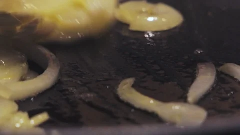 Chef turns the onions into the pot while frying in the oil Video stock 118209501