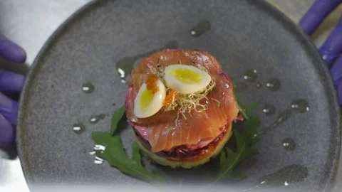 Chef turns a plate with a dish. Greenery on plate salad Video stock 303554762