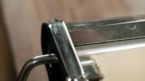 Chef use pasta cutting machine. Traditional italian homemade pasta being made on Stock Footage 150779804