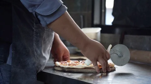Chef use slicing wheel cutting fresh pizza, medium shot slowmotion Stock Footage 122145786