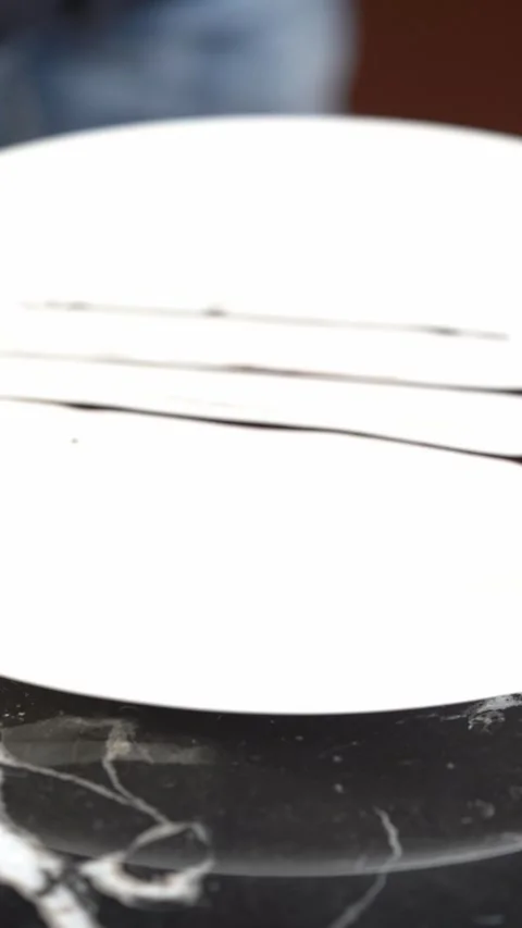 A chef uses a brush to spread sauce on a plate, creating a smooth pattern Stock Footage 327406122