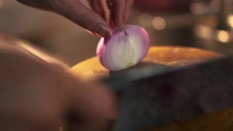 Chef uses a kitchen knife to slice fresh shallots. Stock Footage 199748473