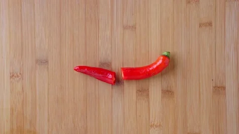 Chef uses a knife to cut the peppers on the cutting board. Red hot chili peppers Stock Footage 145139286