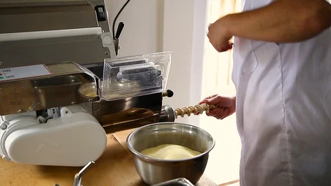 Chef uses a pasta cutting machine to make fresh spaghetti. Stock Footage 95769229