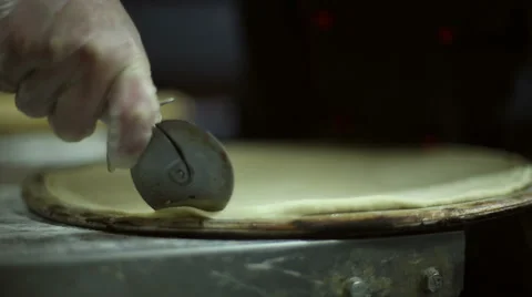 The chef uses roller knife to cut off the excess dough Stock Footage 59699486