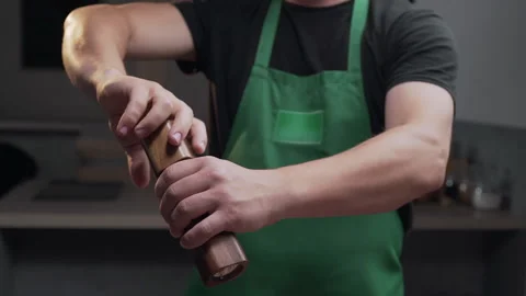 Chef uses salt mill to add some salt for his meal Stock Footage 143780220