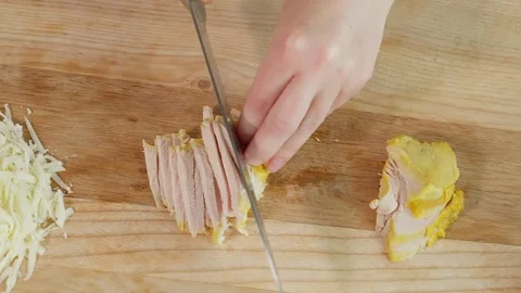 The chef uses a sharp knife to cut boiled turkey meat into sticks Stock Footage 270146246