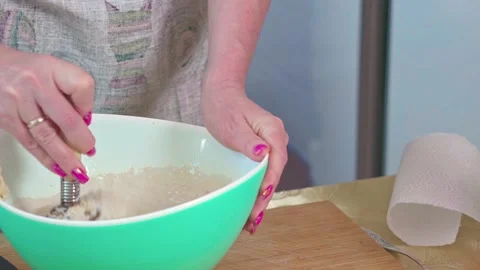 The chef uses a whisk to cook eggs.  Stock Footage 252056772