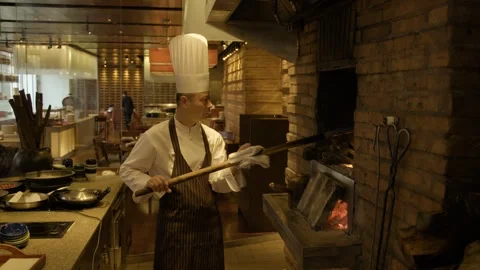 Chef Uses Wood-Fired Oven in Open Beijing Restaurant Kitchen for Food Stock Footage 345782800