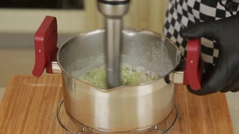 Chef using blender to puree boiled broccoli in a pot while preparing a broccoli Stock Footage 340553824
