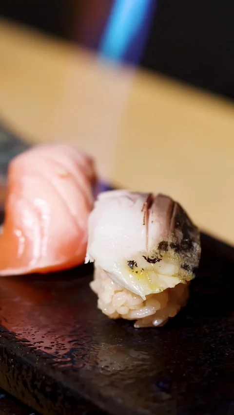 Chef Using Blowtorch to Sear Salmon and White Fish Nigiri Sushi Stock Footage 324945648