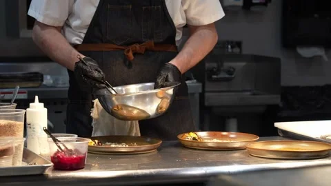 Chef using chopsticks to prepare plates in a fancy kitchen Stock Footage 284230613