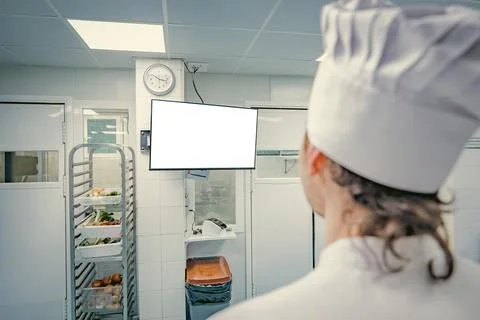 Chef using a computer in a professional kitchen Stock Photos