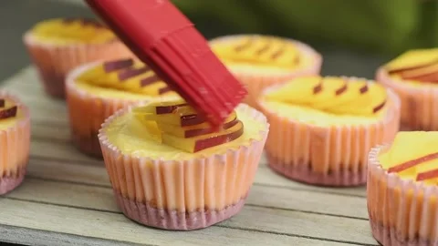 Chef using culinary brush to apply honey on mini nectarine cheesecakes. Stock-Footage 169797875