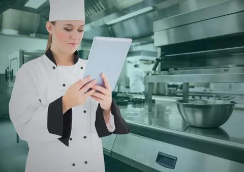Chef using digital tablet in commercial kitchen Stock Photos