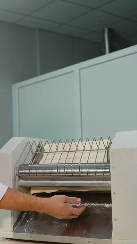 Chef Using Dough Sheeter in Kitchen Stock Footage 299655032