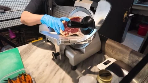Chef Using Electric Deli Slicer to Cut Roast Beef in Kitchen Stock Footage 338326802