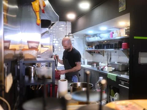 Chef using an electric mixer in the kitchen of a restaurant Stock Photos