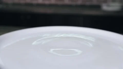 Chef is using forceps and putting a freshly cooked steak on a plate Stock Footage 132779916