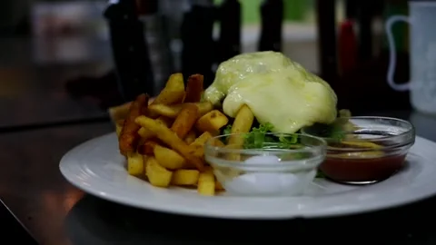 Chef using kitchen torch on burger with melting cheese making hamburger raw.. Stock Footage 263965973