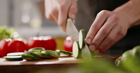 Chef using a knife cutting fresh raw sqaush. Cooker at home making a healthy Stock Footage 144495922