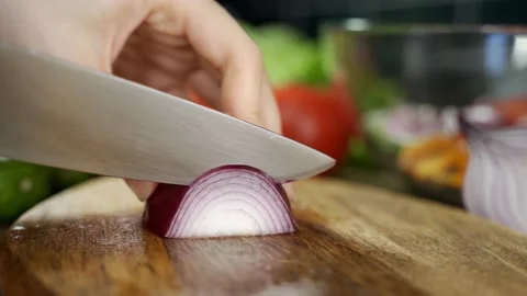 Chef using a knife cutting fresh raw onions. Stock Footage 149026611