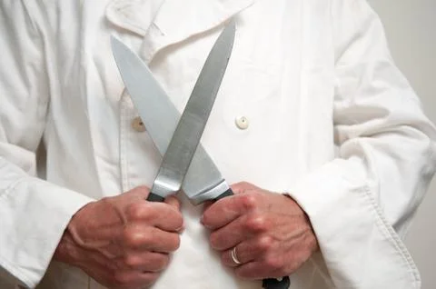 Chef using knife held in front of him Stock Photos
