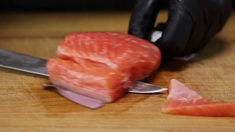 The chef is using a knife to separate the trout fillet Stock Footage 122995237