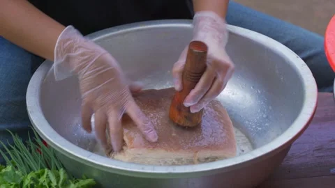 A chef is using a needle board to prick the pork belly, preparing for the prepar Stock Footage 287734634
