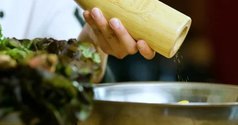 Chef using pepper mill to grind pepper in the bowl Stock Footage 80429093