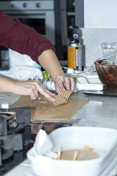 Chef using plastic to finish a caramel chocolate decoration. Stock Photos