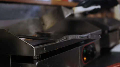 Chef Using Spatula and Tongs for Frying with Bacon in Background Stock-Footage 307086648