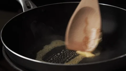 Chef using spatula wooden melting butter on the pan butter before cooking Stock Footage 120214249
