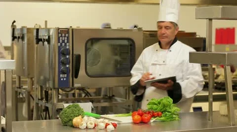 Chef using a tablet computer for taking notes Stock Footage