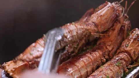 Chef Using Tongs to Arrange Grilled Mantis Shrimp on Platter - Close-Up 動画素材 344219341