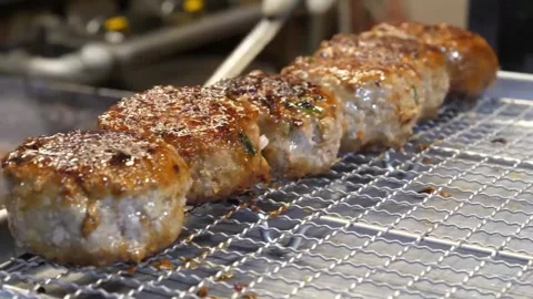 Chef Using Tongs to Place Grilled Meat Patties on Wire Cooling Rack Video stock 343587245