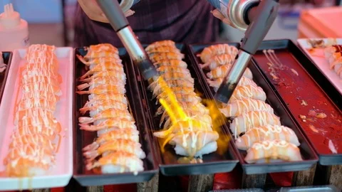 Chef using the torch to burn Sushi Rolls on Street Food Stock Footage 108496167