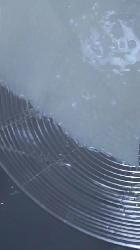 Chef using a wire skimmer to place the first boiled dough sheet into a carved wo Stock Footage 342627954