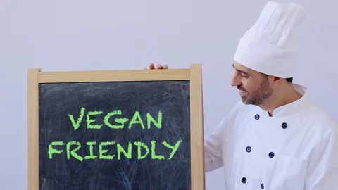 Chef with VEGAN FRIENDLY sign Stock Footage 75823847