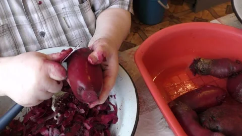 The chef washes and peels the beets with a knife Stock Footage 166707005