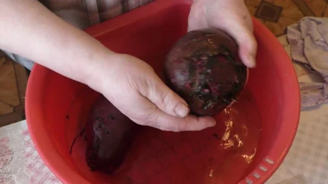 The chef washes the beets in water Stock Footage 165038377