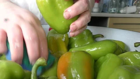 The chef washes the green pepper with water Stock Footage 138720952