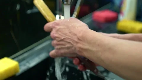 A chef washes a knife under the tap in the kitchen Stock Footage 331602031