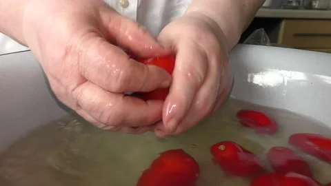 The chef washes the tomatoes with water Stock Footage 138721228