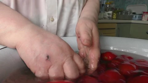 The chef washes the tomatoes with water Stock Footage 138721362